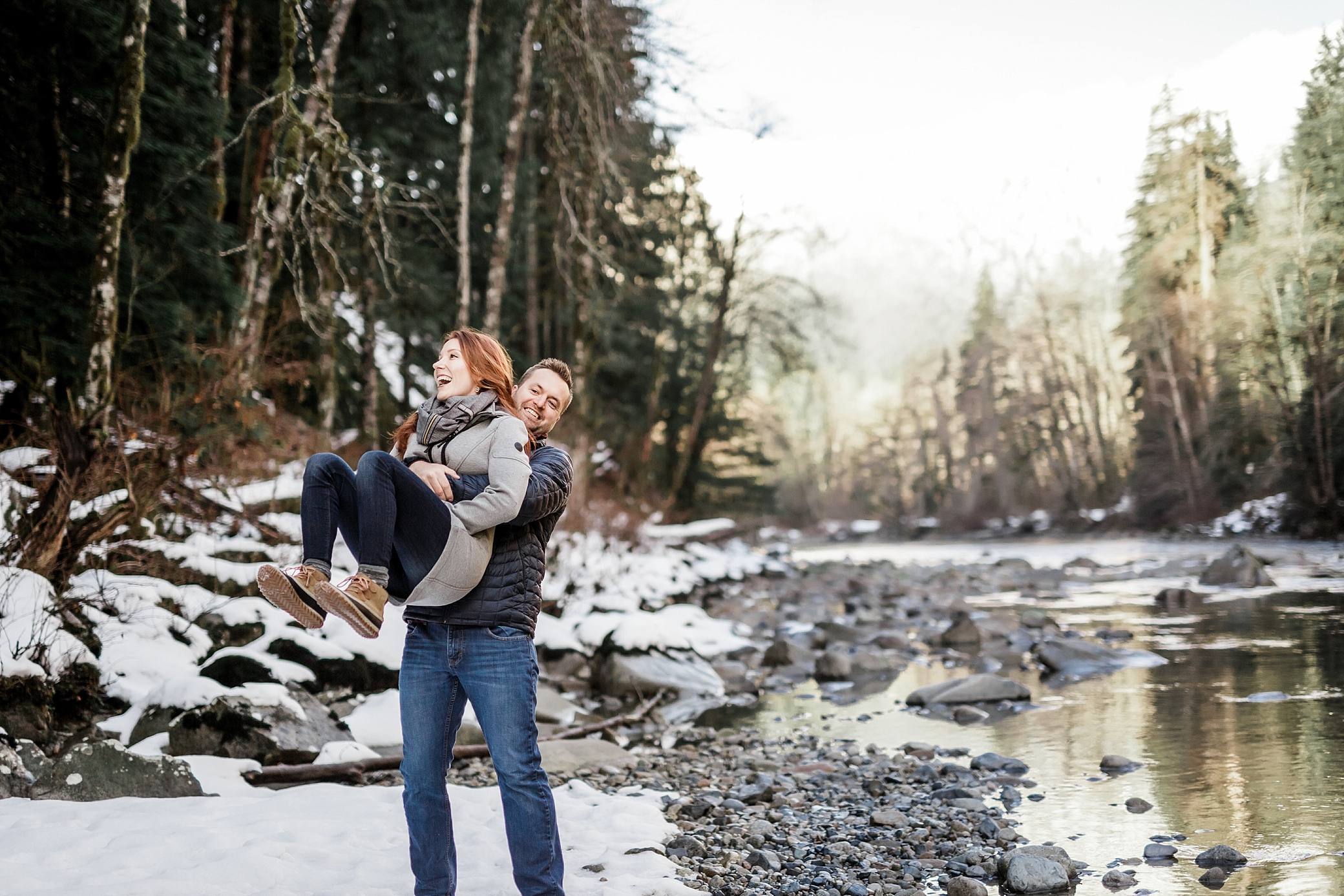 Couple playing in the snow during their Middle Fork Engagement Session with Seattle Wedding Photographer, Megan Montalvo Photography