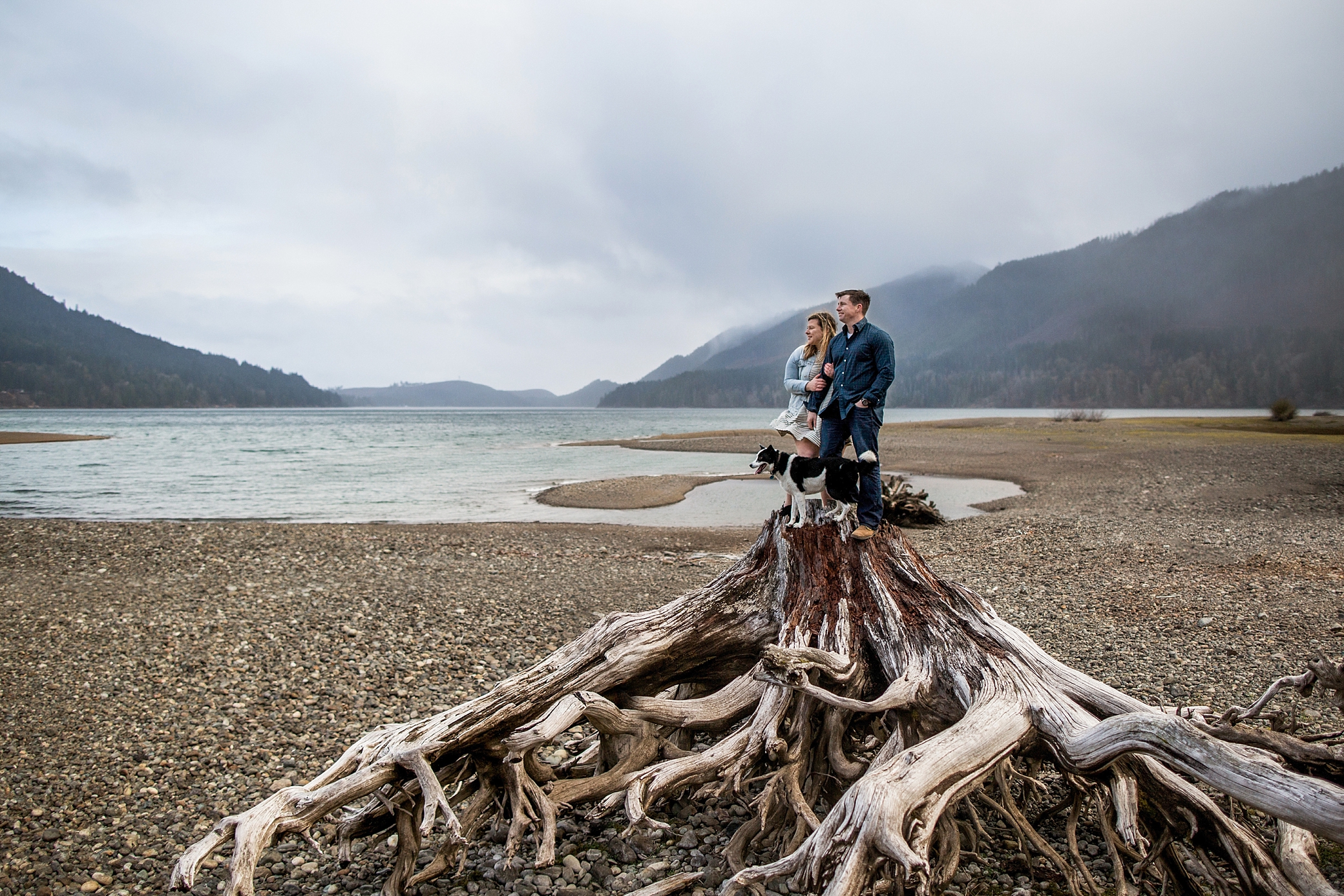 Couple and dog looking out over Lake Cushman | Megan Montalvo Photography