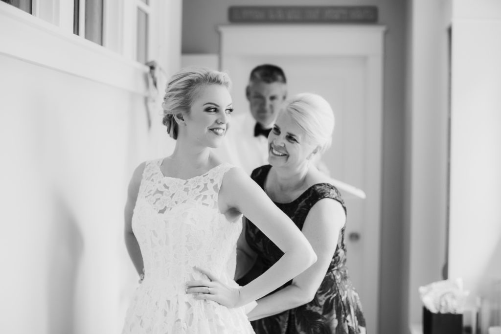 Mom helping daughter get on her wedding dress | Megan Montalvo Photography 