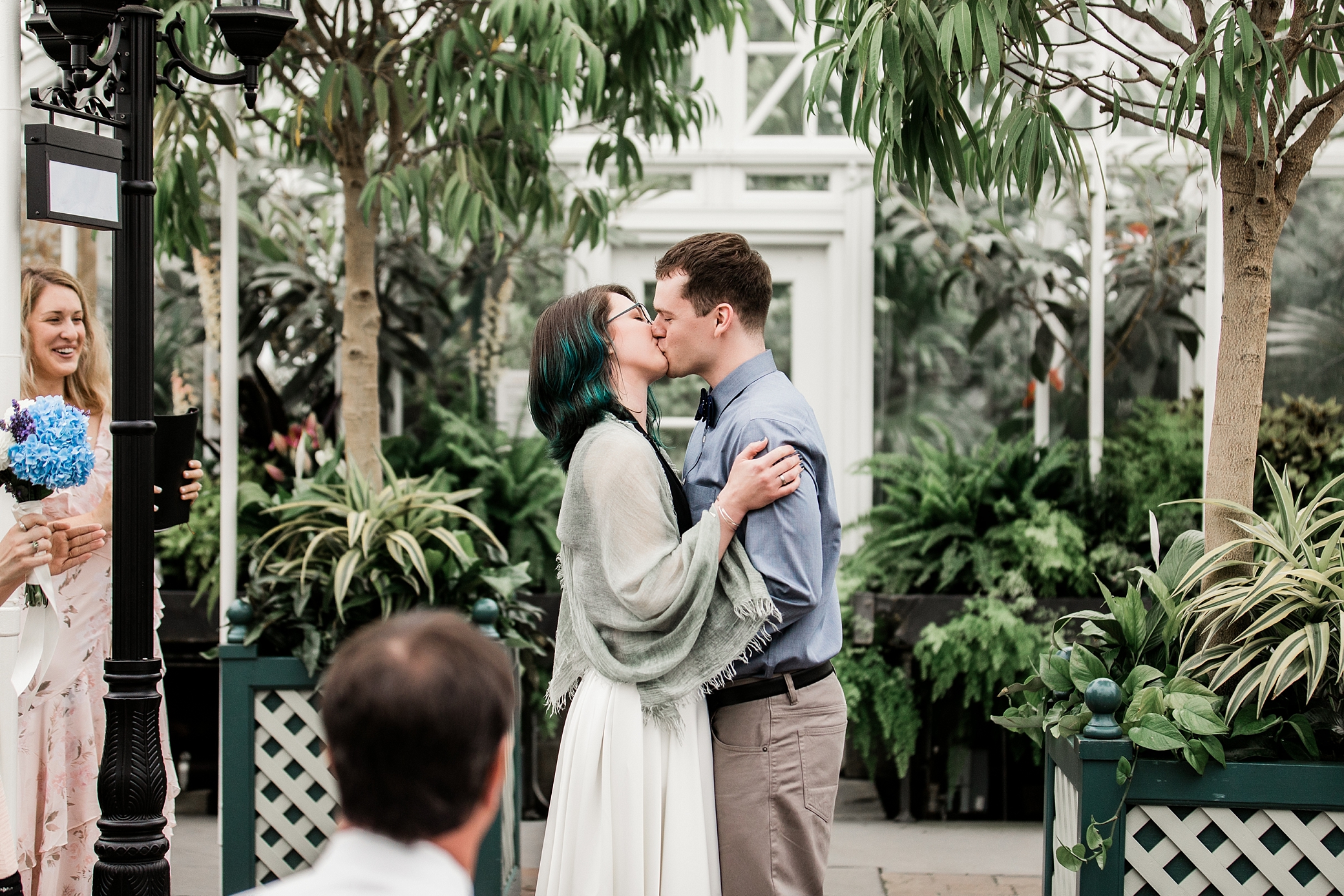 Bride and groom first kiss at Volunteer Park Conservatory Wedding Ceremony photographed by Seattle Wedding Photographer, Megan Montalvo Photography 