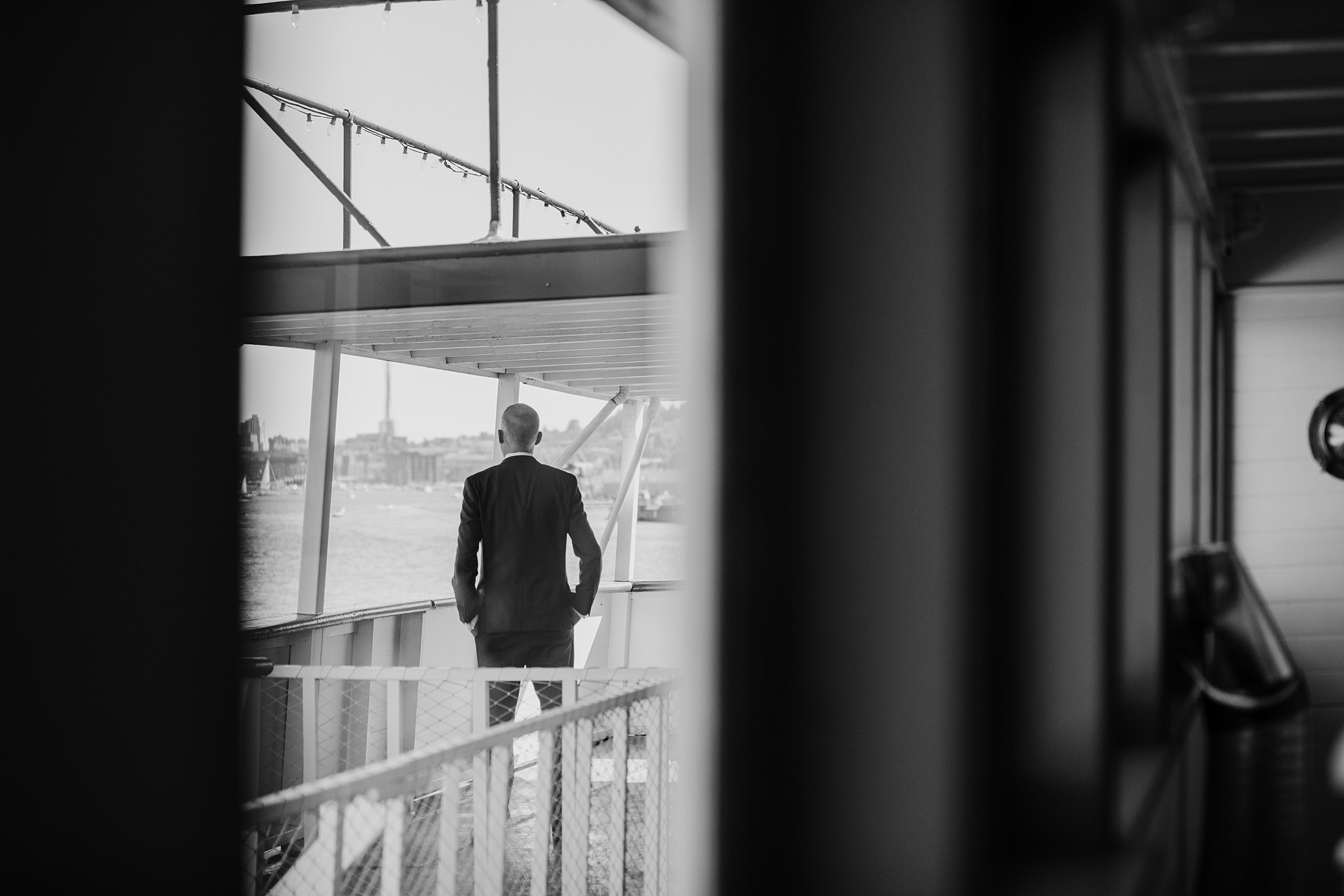 Groom waiting on his bride for first look on Seattle's waterfront wedding venue, MV Skansonia. Waterfront wedding photographed by Megan Montalvo Photography. 