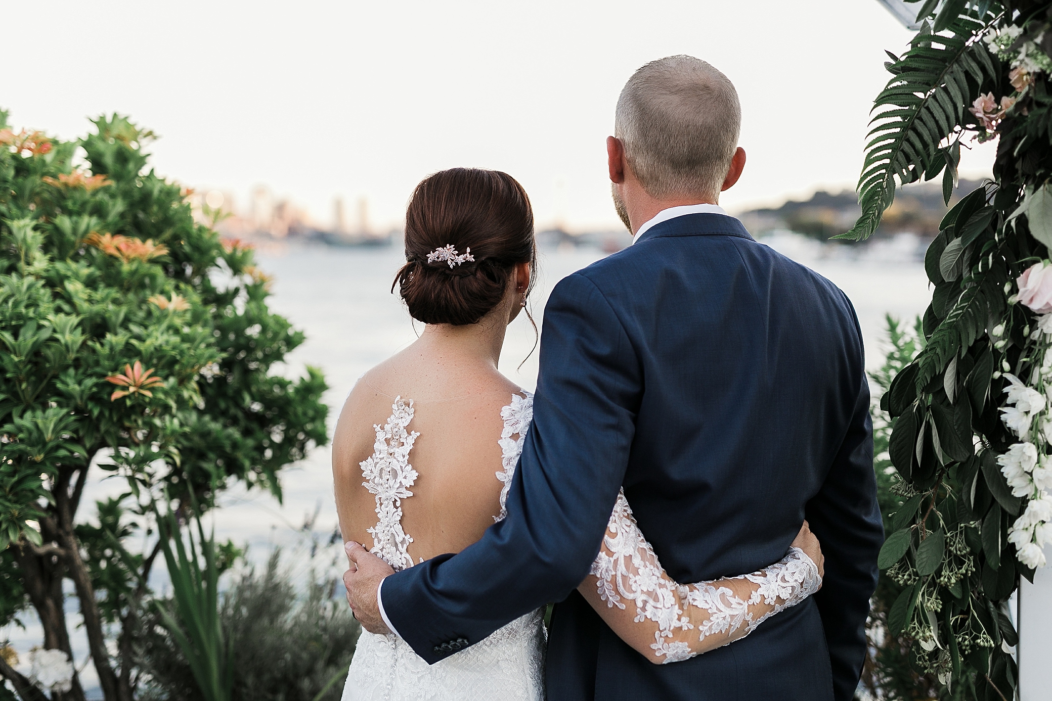 Bride and groom take in the Seattle skyline at their Seattle Waterfront Wedding on the MV Skansonia | Megan Montalvo Photography 