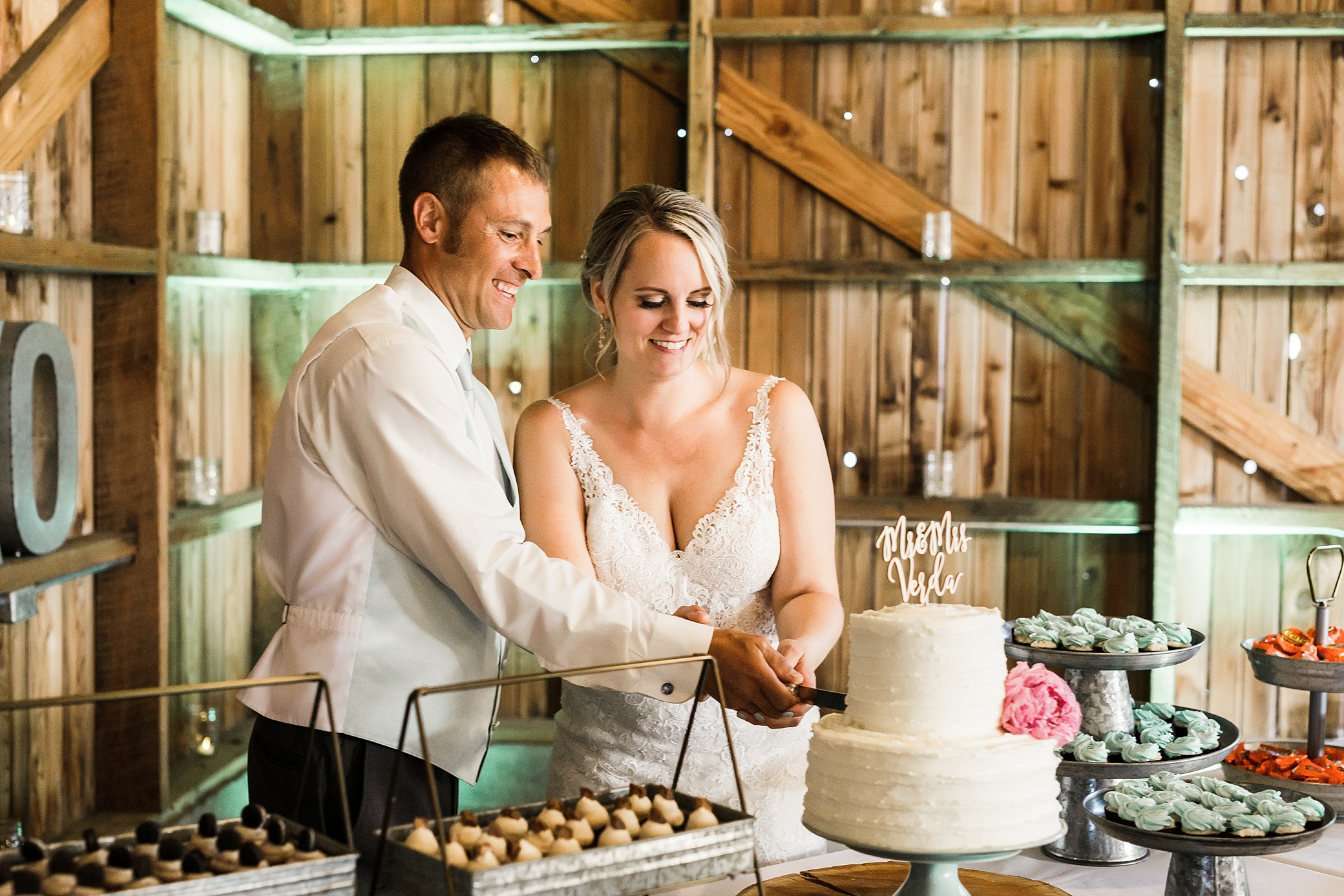 Bride and groom cutting the cake during reception at Maplehurst Farm Wedding Venue in Mount Vernon, WA. Photographed by Washington Wedding Photographer, Megan Montalvo Photography. 