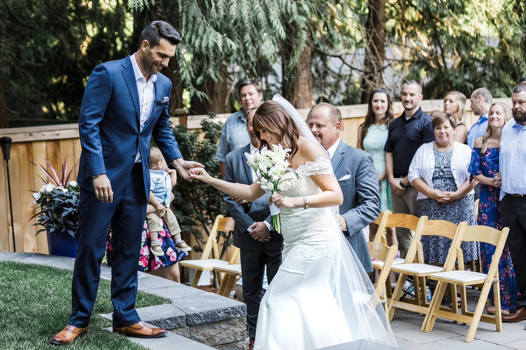 Dad hands over his daughter to her groom at Tacoma backyard wedding ceremony. Photographed by Tacoma-Seattle Wedding Photographer, Megan Montalvo Photography