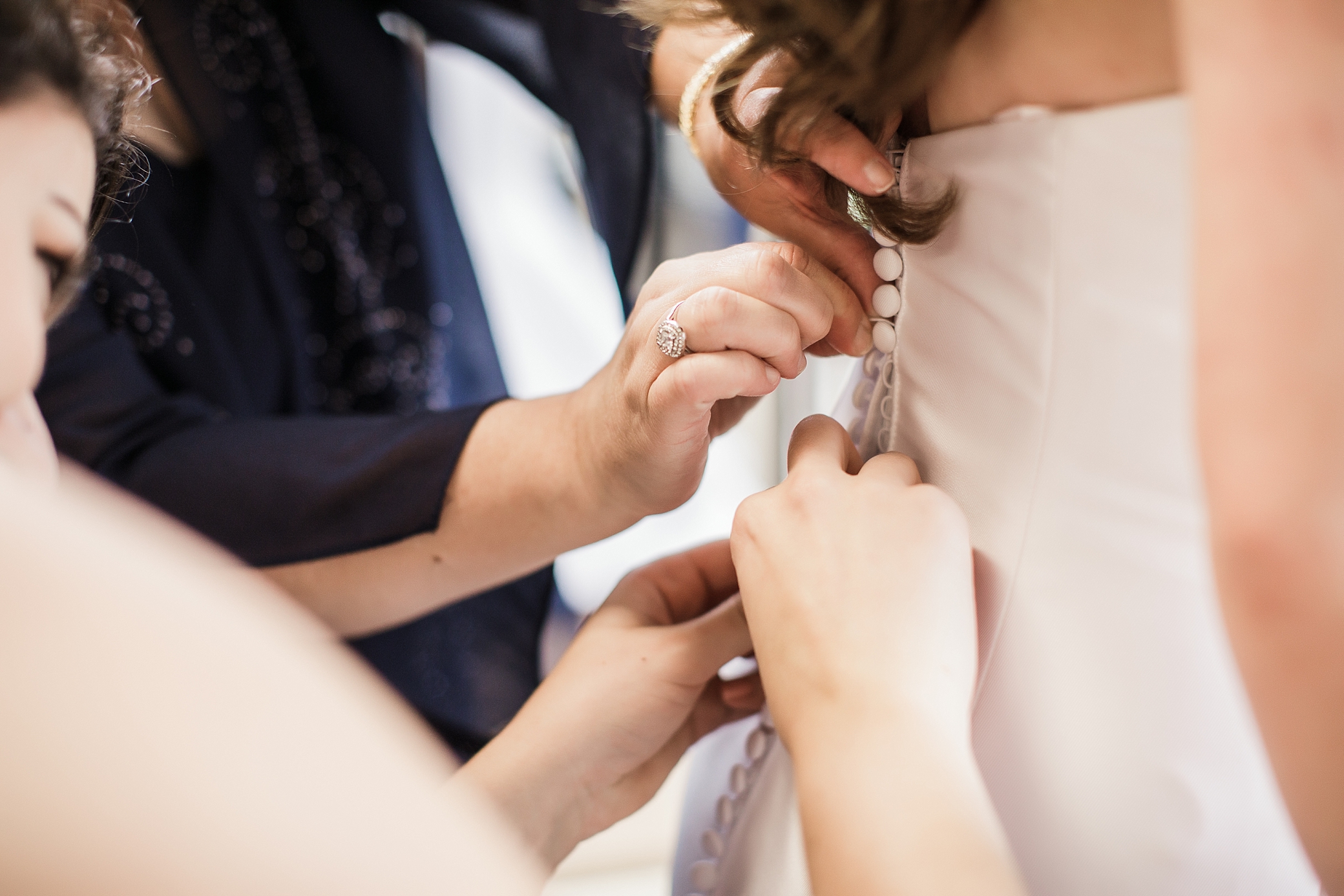 Bride putting on her wedding dress for wedding at Eaglemont Golf Course. Photographed by Mount Vernon Wedding Photographer, Megan Montalvo Photography. 