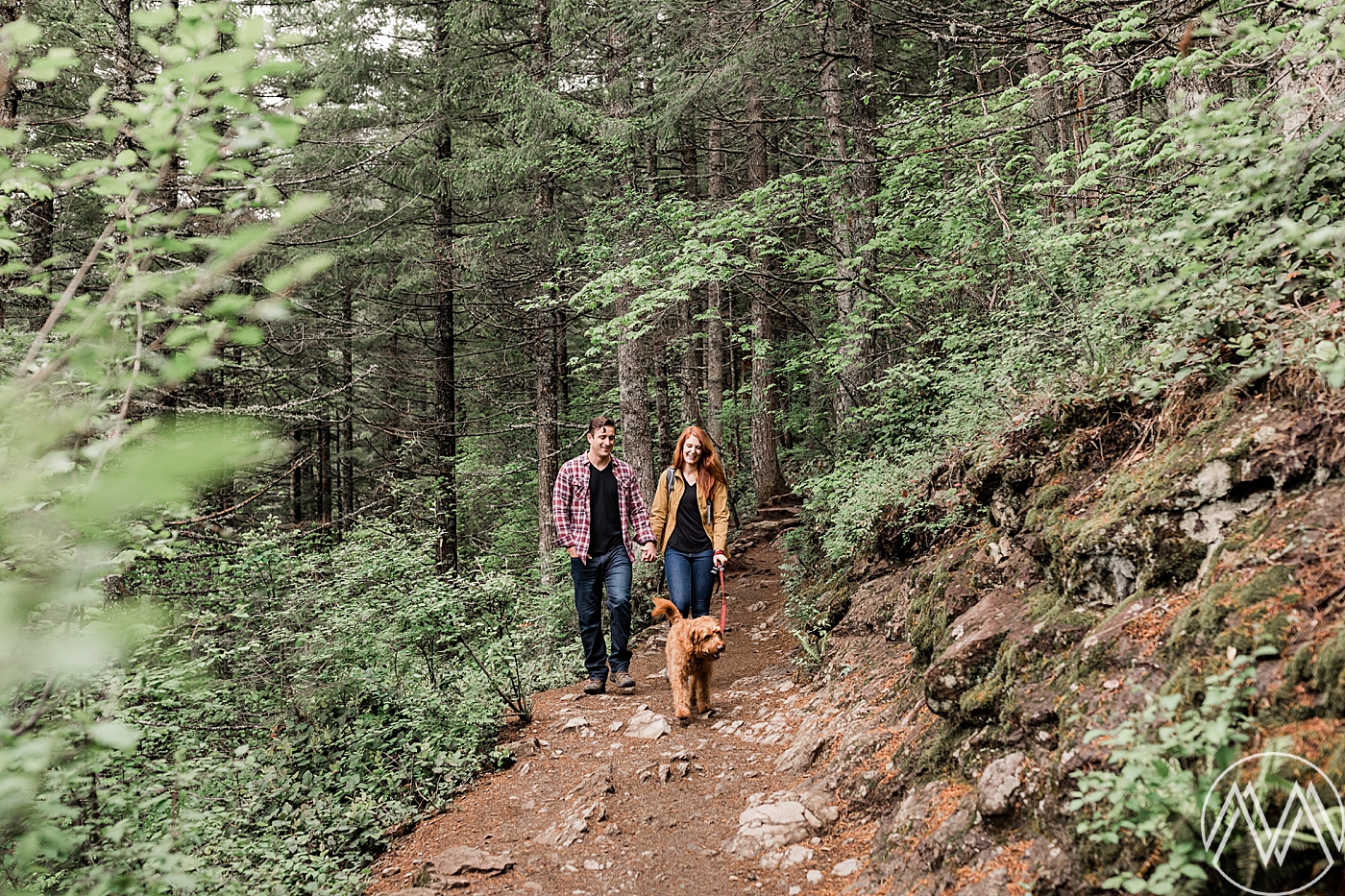 Couple hiking with dog at Rattlesnake Lake during engagement session with Seattle Wedding Photographer, Megan Montalvo Photography. 