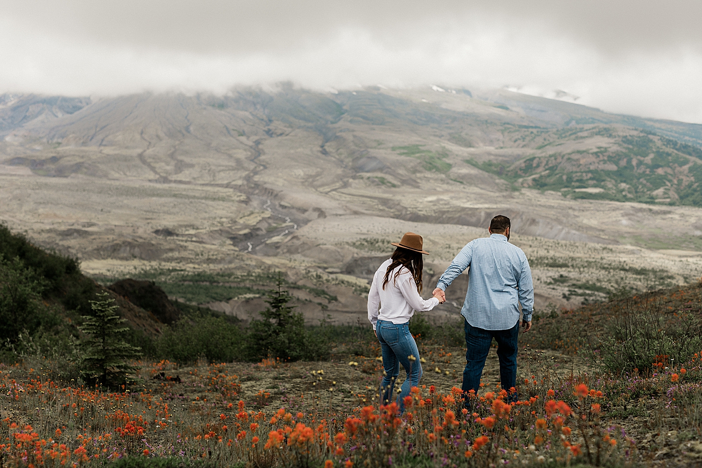 Couple holding hands walking at Mt. St. Helens