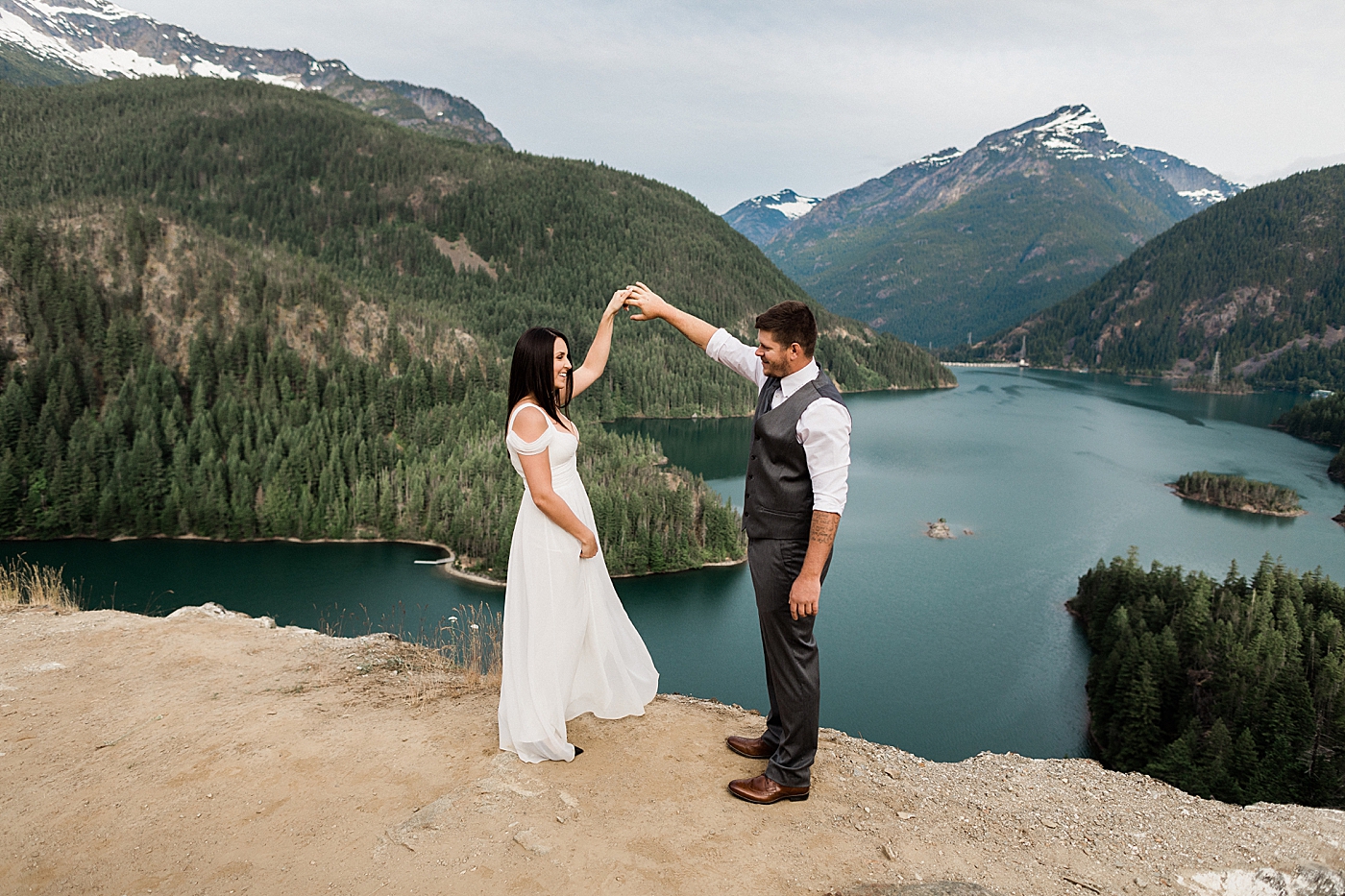 Couple dancing during engagement session overlooking Diablo Lake in Washington | Megan Montalvo Photography