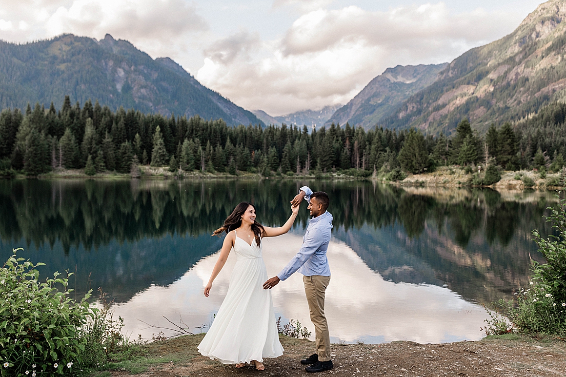 Couple dancing at Gold Creek Pond during summer engagement session. Photographed by Seattle-Tacoma Wedding Photographer, Megan Montalvo Photography. 