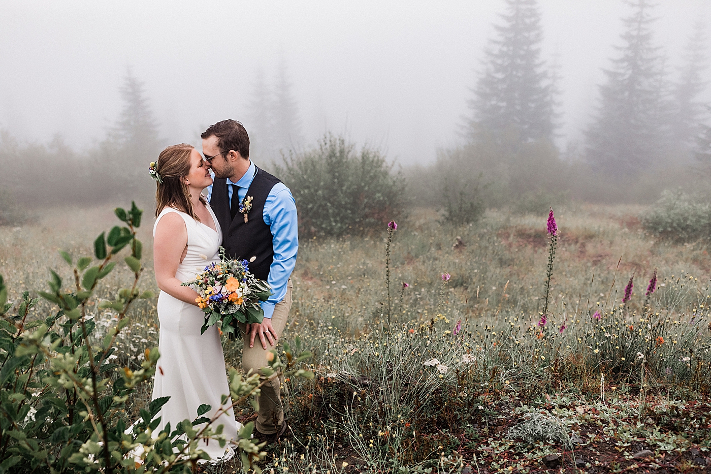 Bride and groom adventure through the beautiful Mount St. Helens wildflowers in the rain after elopement ceremony. Photographed by PNW Elopement Photographer, Megan Montalvo Photography. 