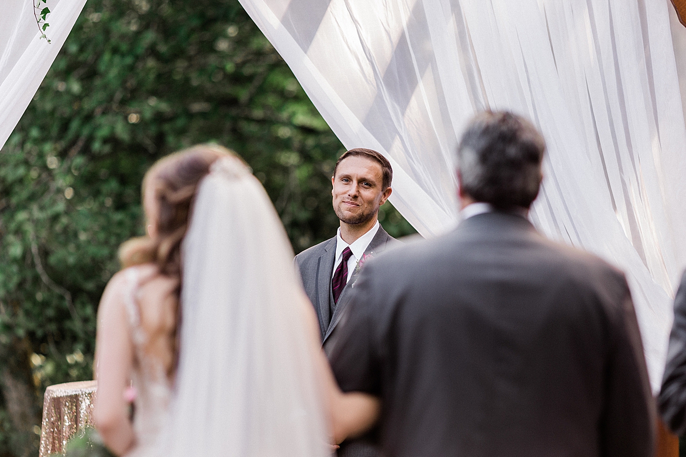 Bride walking down aisle and grooms reaction | Cedar Springs Wedding | Megan Montalvo Photography