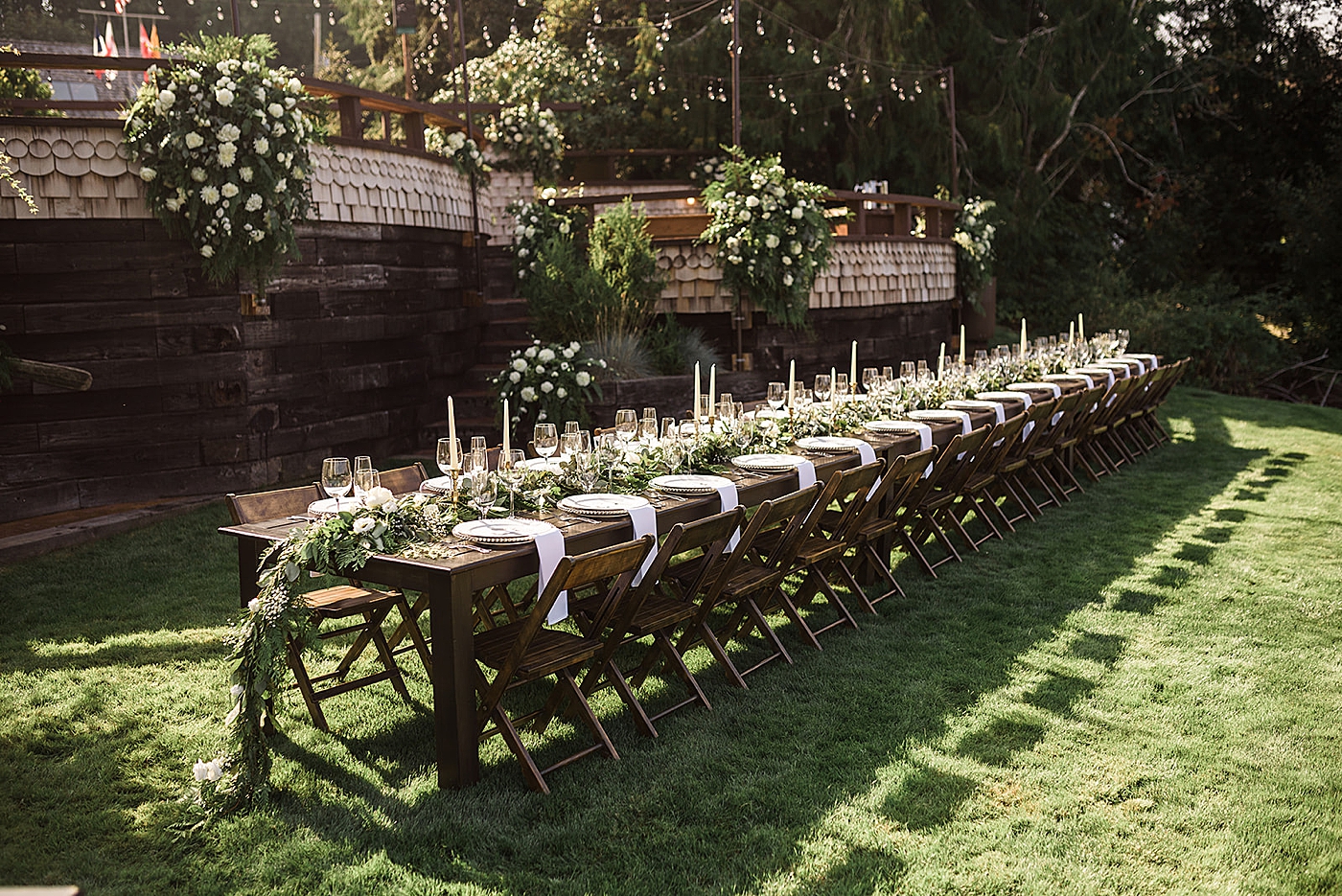 Beautiful farmhouse table at backyard wedding reception. Tables provided by Olympic Farmstyle Events and photographed by Tacoma Wedding Photographer, Megan Montalvo Photography. 