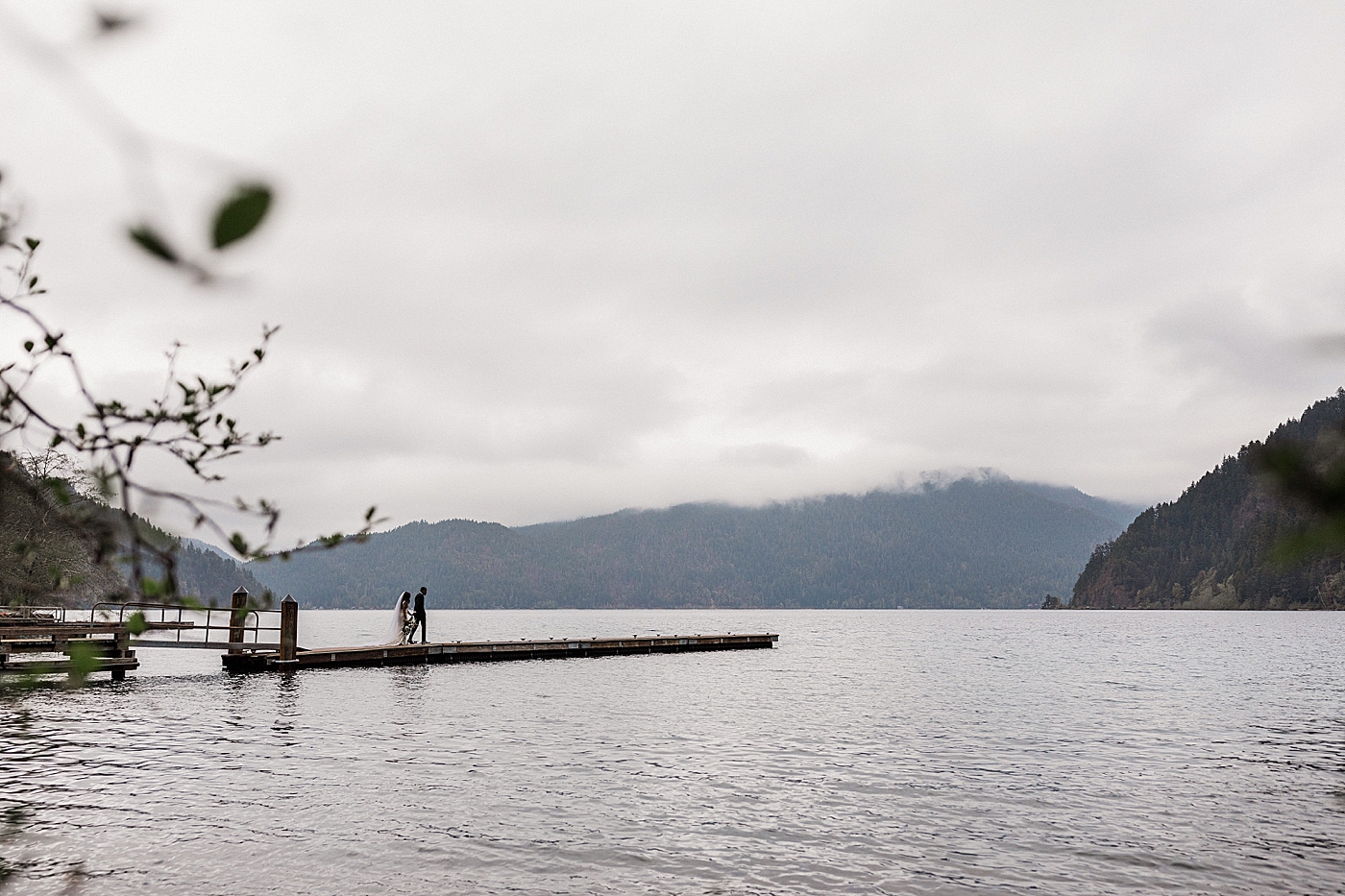 Couple walks out onto dock at Lake Crescent. Photo by Megan Montalvo Photography.