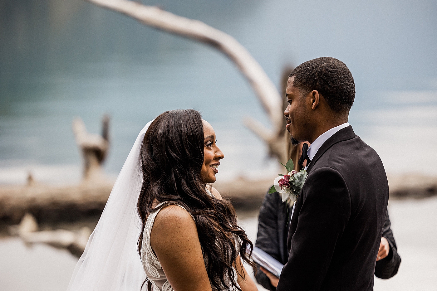 Bride and Groom smiling during vows at elopement | Photo by Megan Montalvo Photography