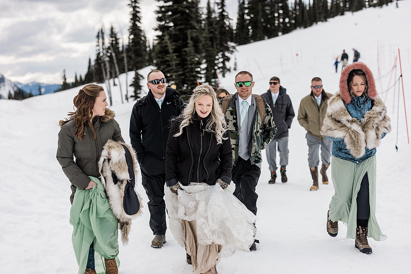 Wedding party hiking to elopement ceremony spot at Mt Rainier. Photo by Megan Montalvo Photography.