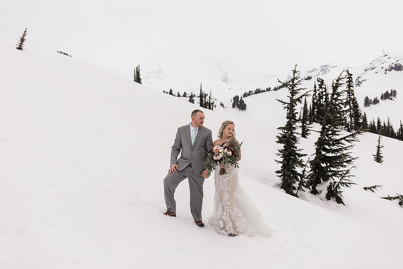 Bride and groom portraits in the snow at Mt Rainier. Photo by Megan Montalvo Photography.