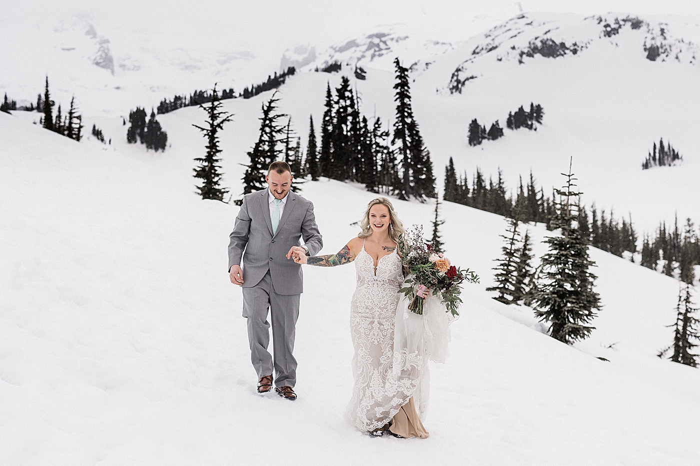 Bride and groom photos in the snow at Mt Rainier. Photo by Megan Montalvo Photography.