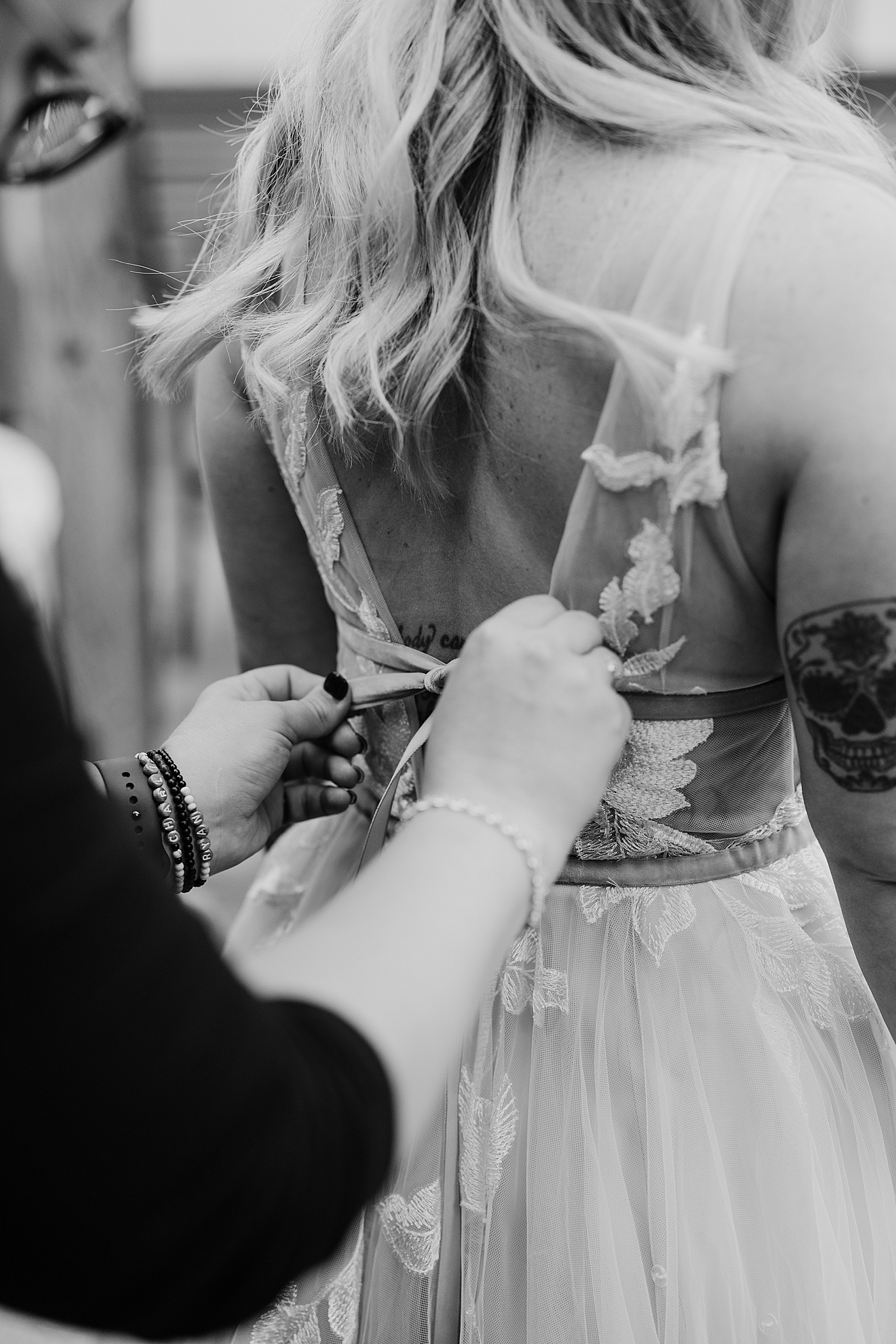 Bride getting into wedding dress. Photo by Megan Montalvo Photography.