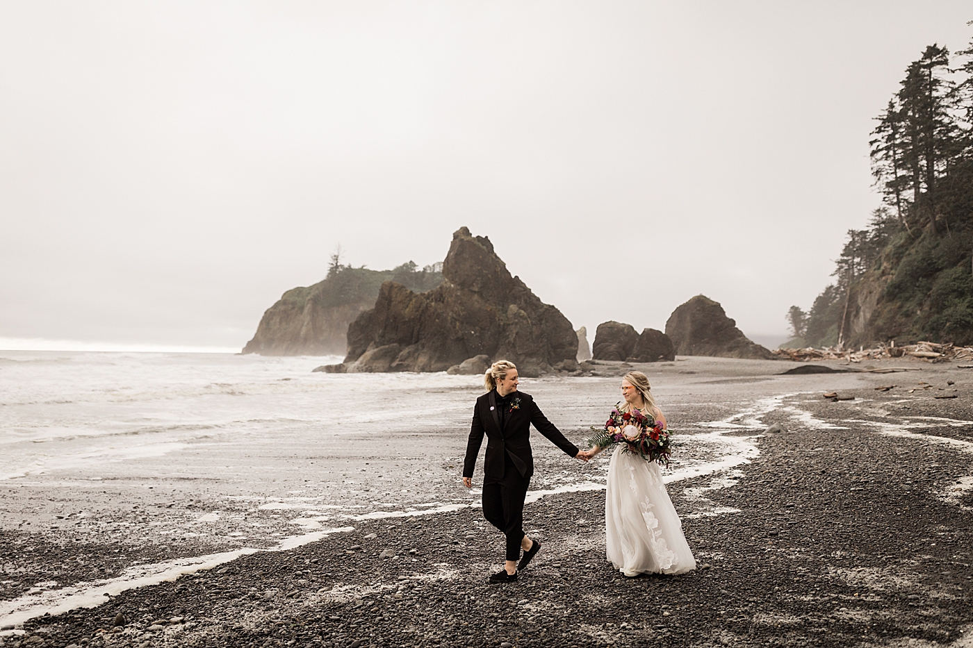 Brides walking along the water at Ruby Beach. Photo by Megan Montalvo Photography.