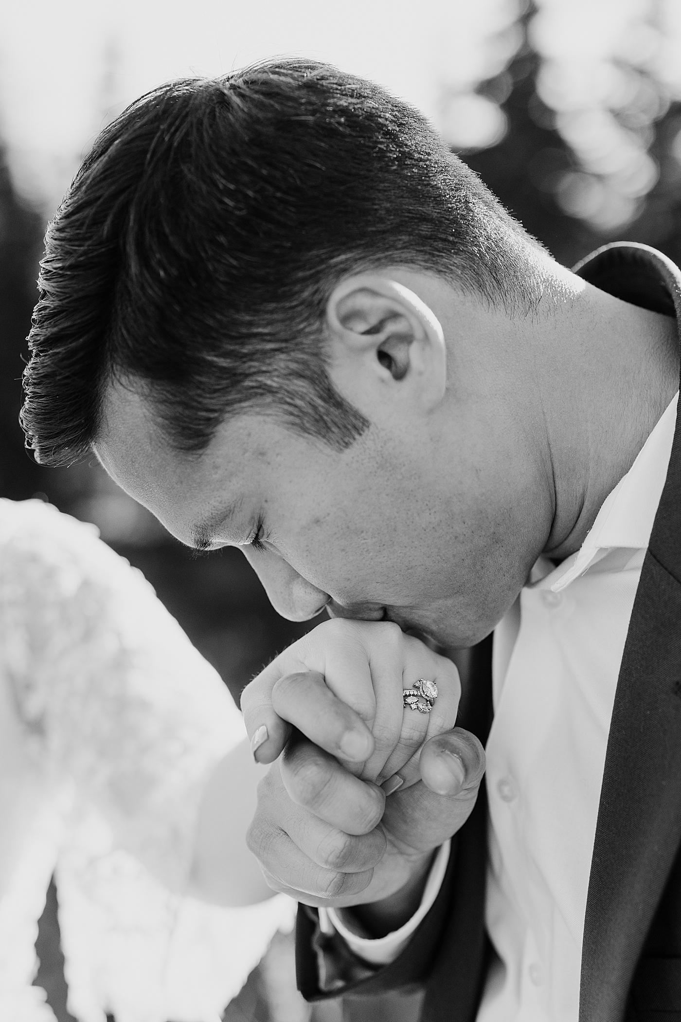 Groom kissing brides hand. Photo by Megan Montalvo Photography.