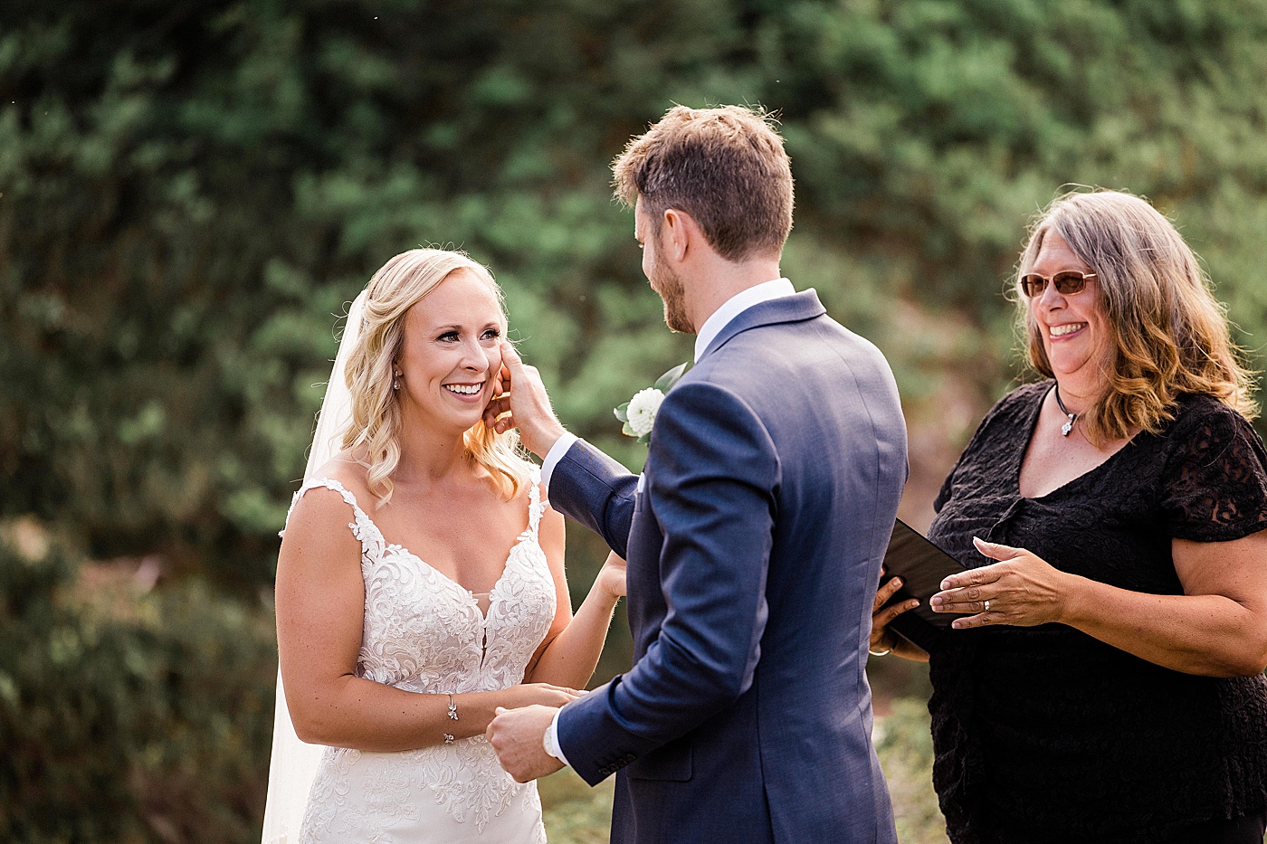 Groom wipes tear from bride during elopement ceremony at Mount Baker. Photo by Megan Montalvo Photography.