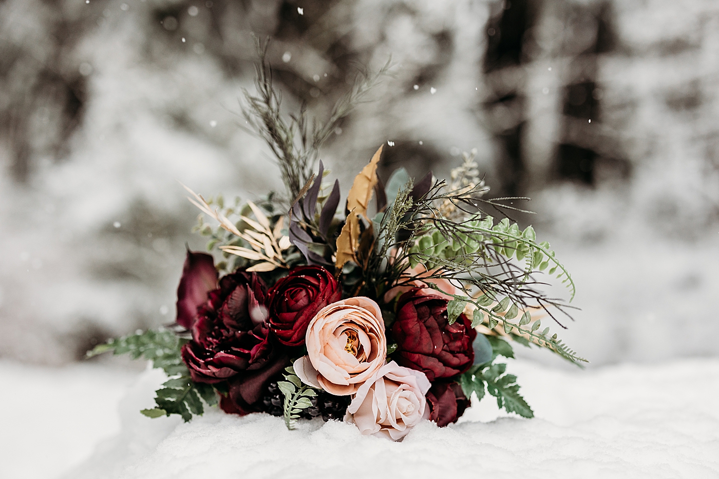 Bridal bouquet in the snow. Photo by Megan Montalvo Photography.