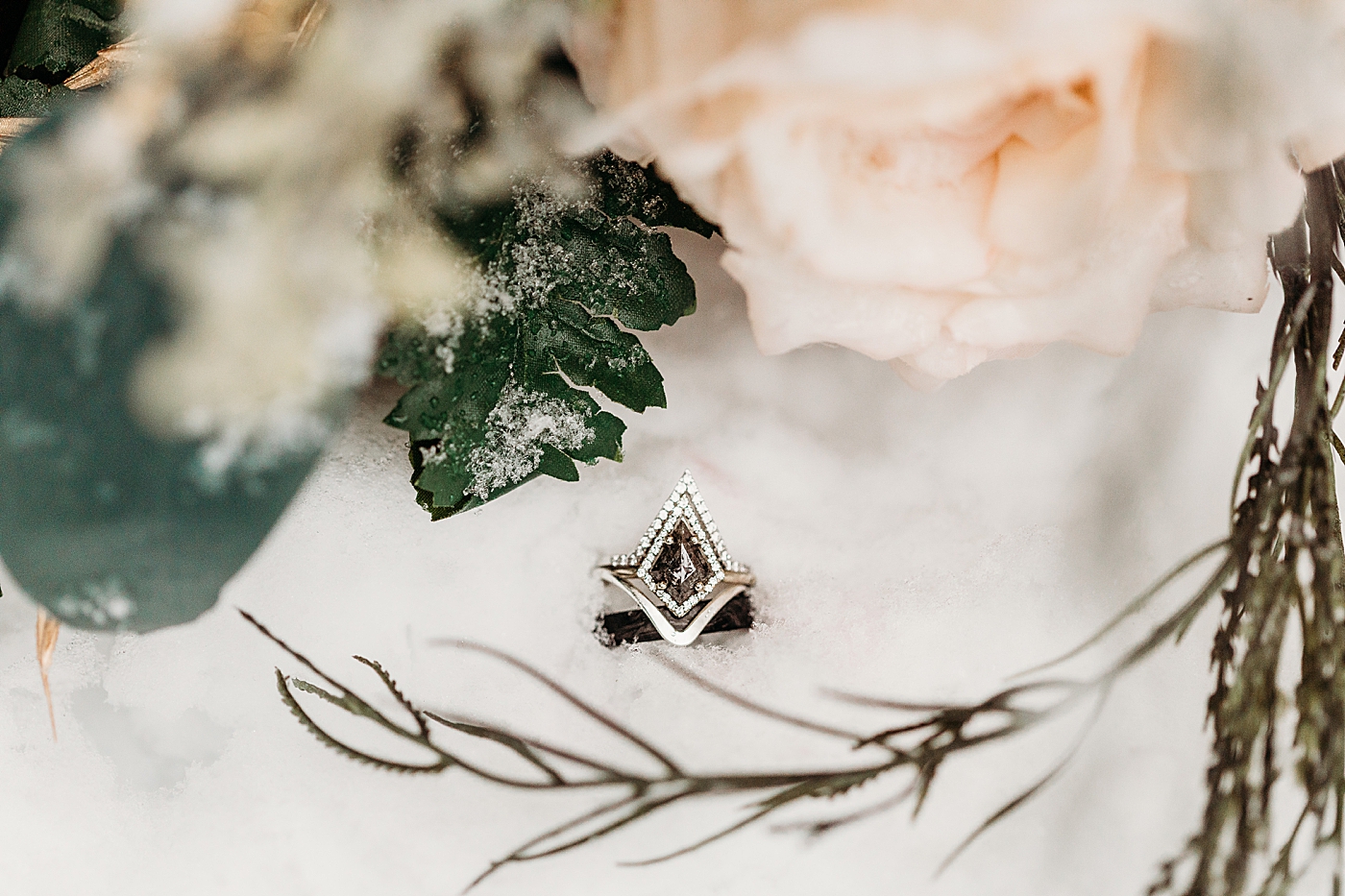 Wedding ring details in the snow. Photo by Megan Montalvo Photography.