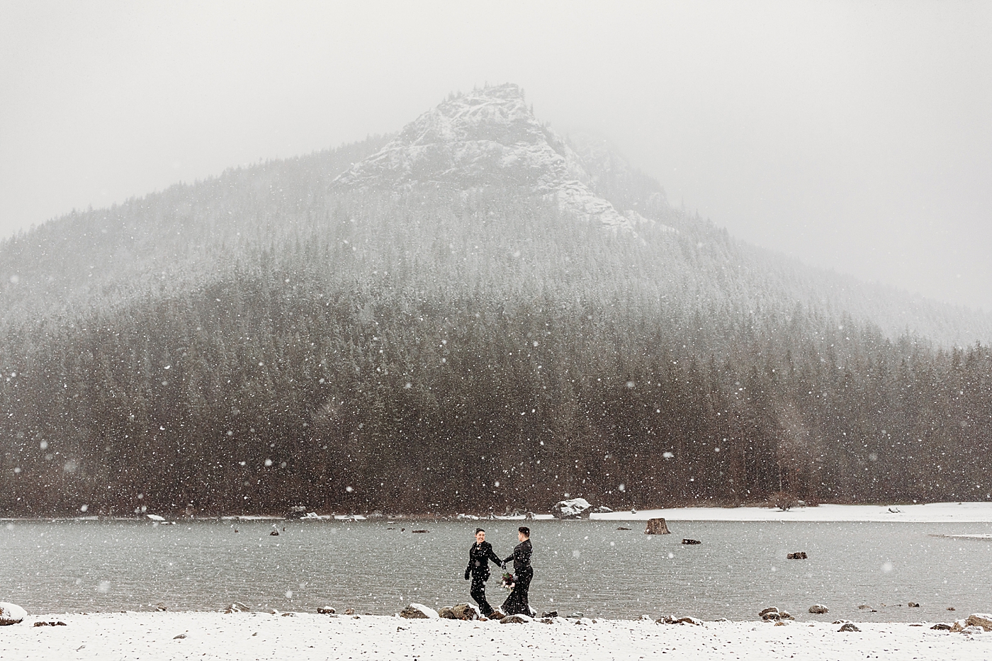 Couple walking along Rattlesnake Lake in the snow. Photo by Megan Montalvo Photography.