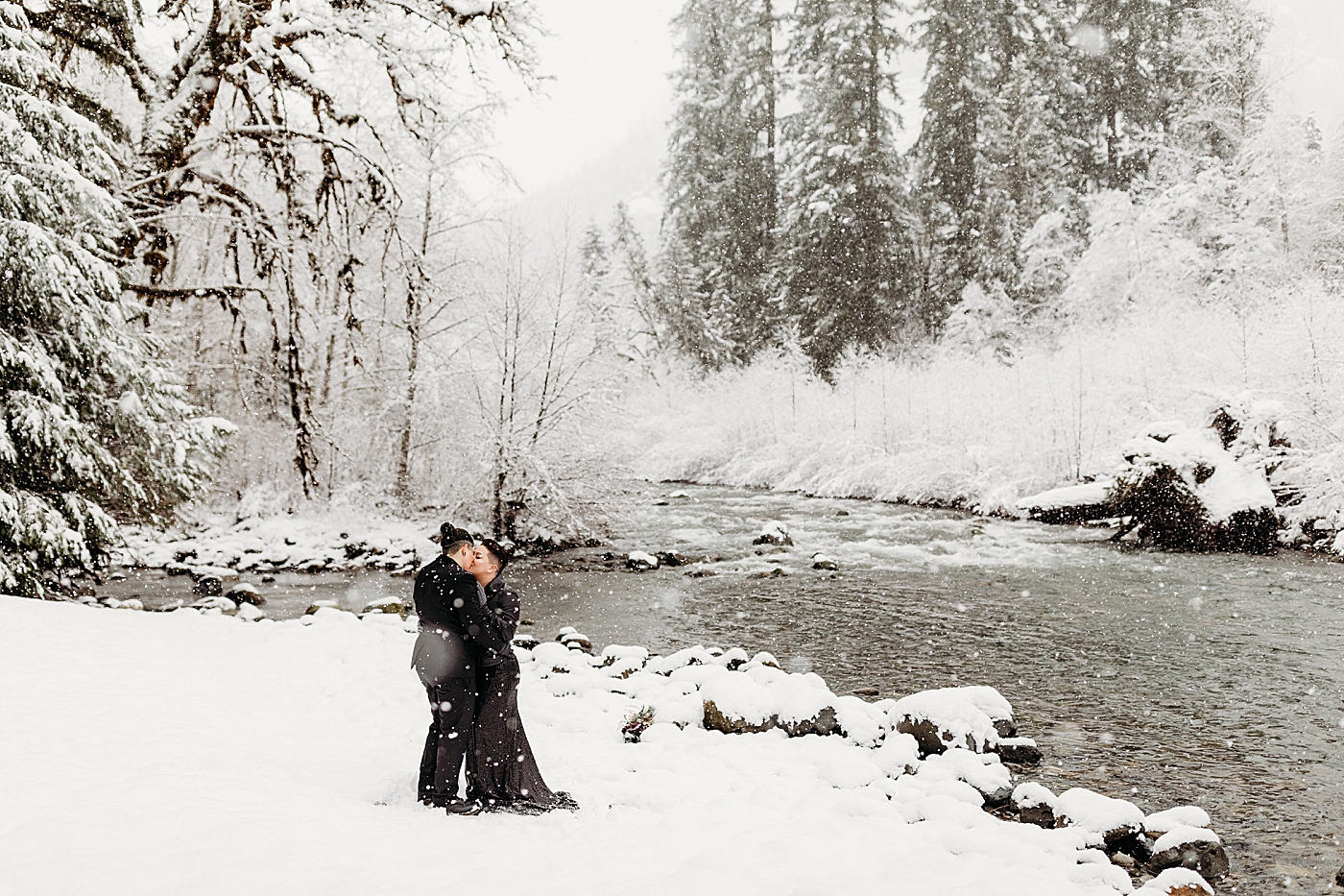 Couple kissing along the Snoqualmie River during elopement. Photo by Megan Montalvo Photography.