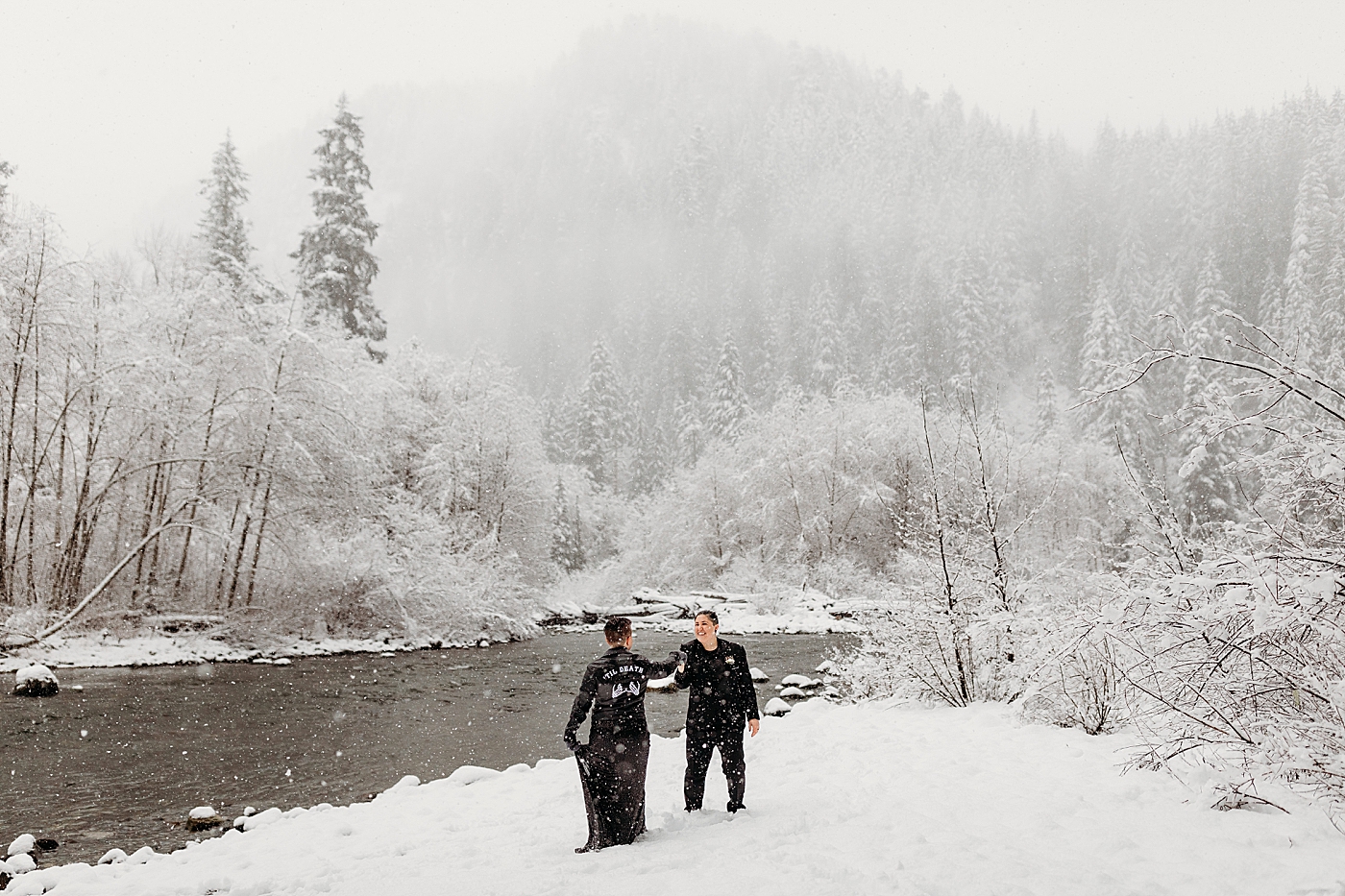Couple playing in the snow during elopement. Photo by Megan Montalvo Photography.