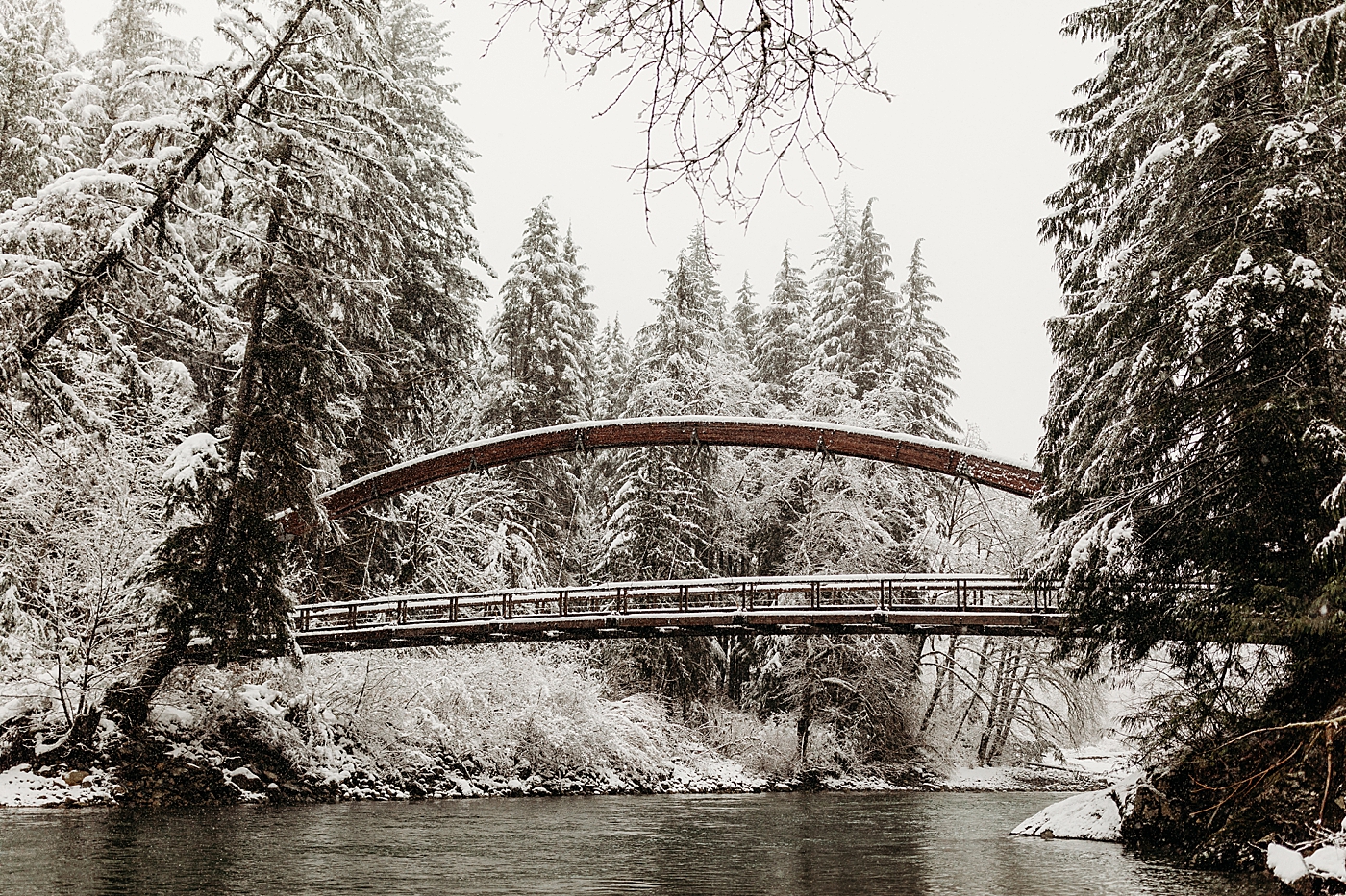 Middle Fork bridge in the winter with snow. Photo by Megan Montalvo Photography.