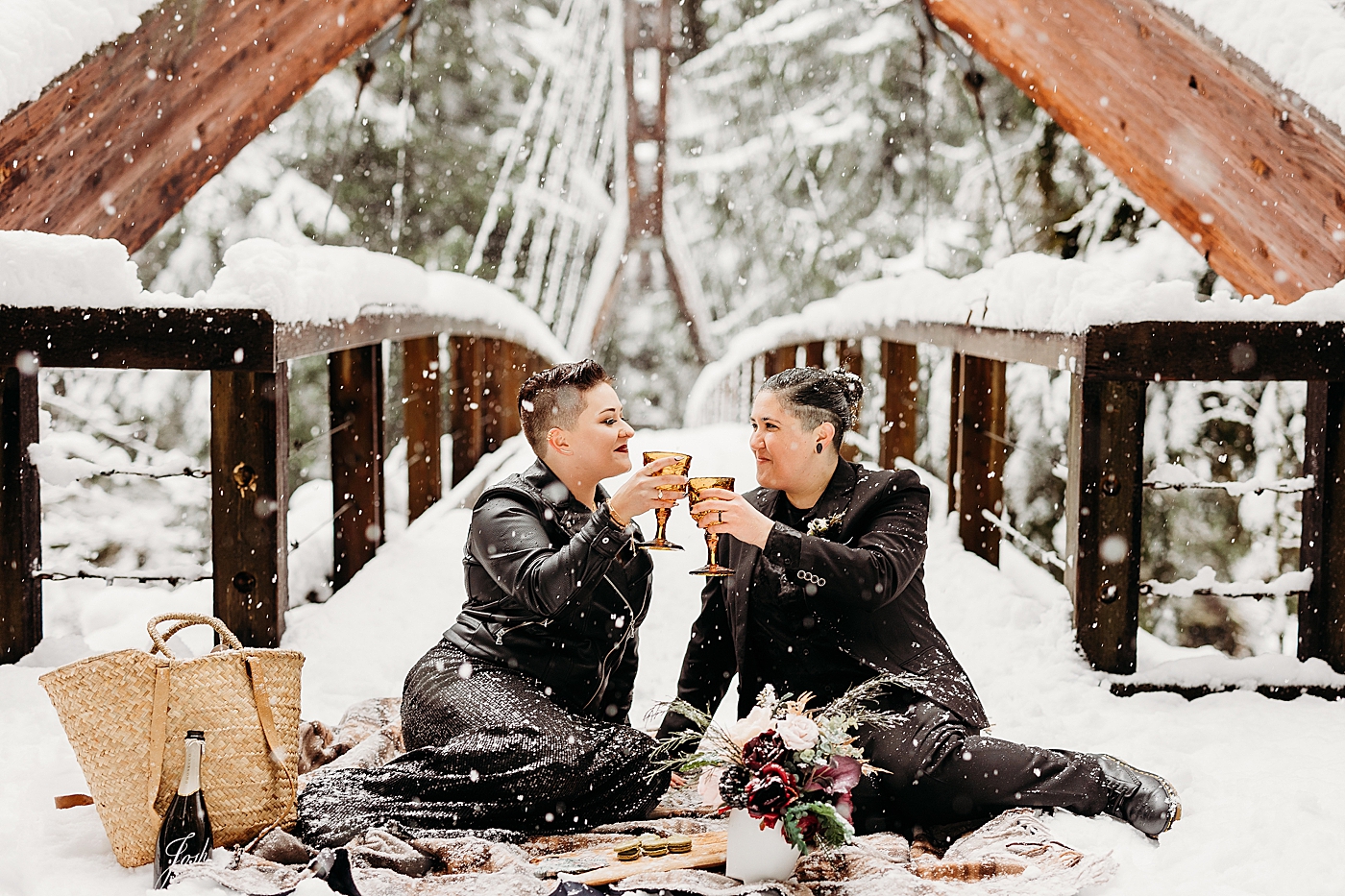 Couple having a picnic in the snow at Middle Fork bridge. Photo by Megan Montalvo Photography.