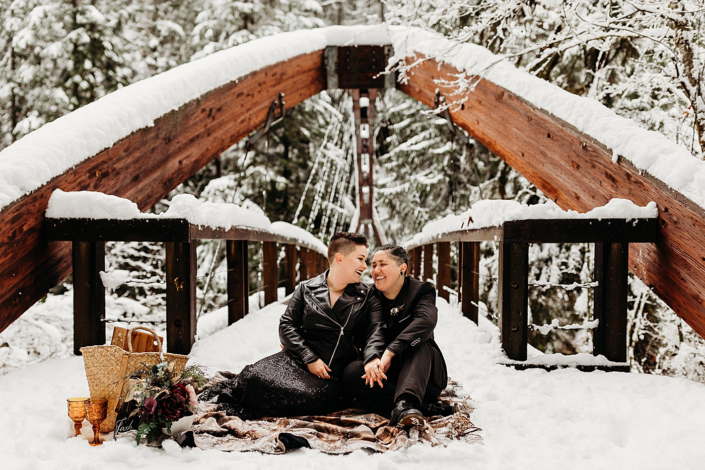 Couple having a picnic in the snow at Middle Fork bridge. Photo by Megan Montalvo Photography.