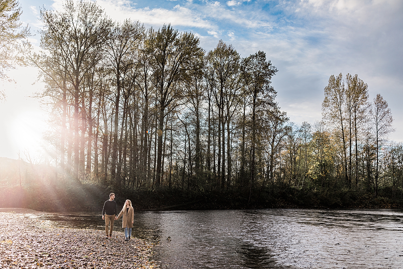 Couple walking along Snoqualmie River for engagement photos. Photo by Megan Montalvo Photography.