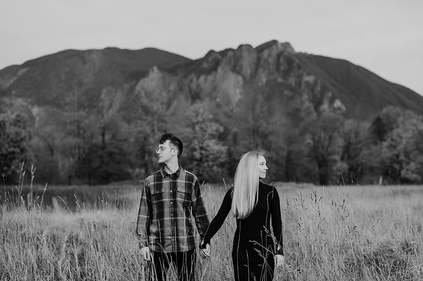 Black and white photo of couple looking off in different directions. Photo by Megan Montalvo Photography.