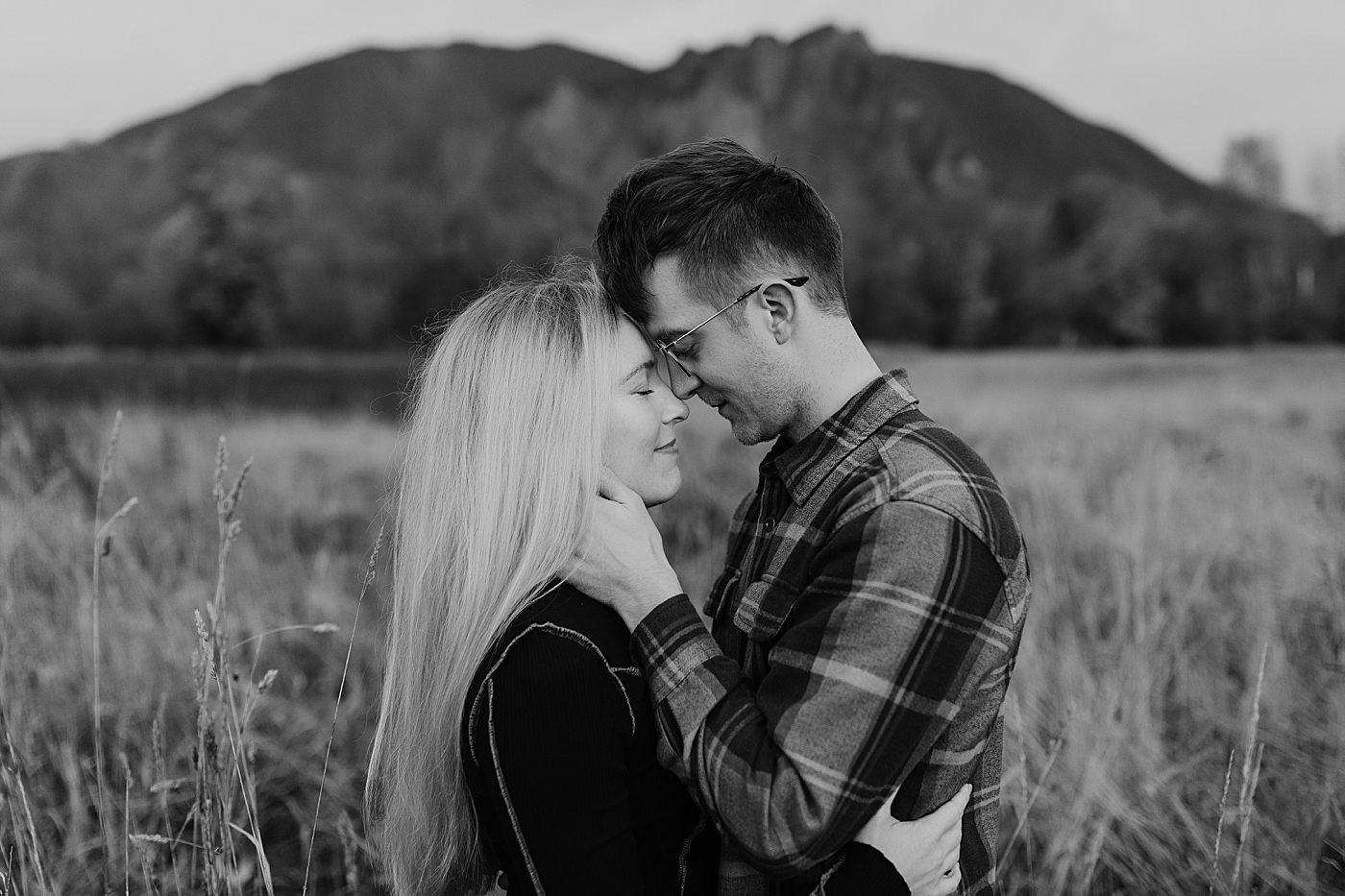 Couple forehead to forehead for photos during engagement session. Photo by Megan Montalvo Photography.