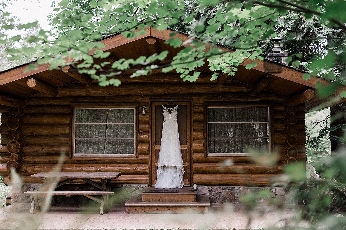 Wedding dress hanging from door on cabin in Mt. Baker. Photo by Megan Montalvo Photography.