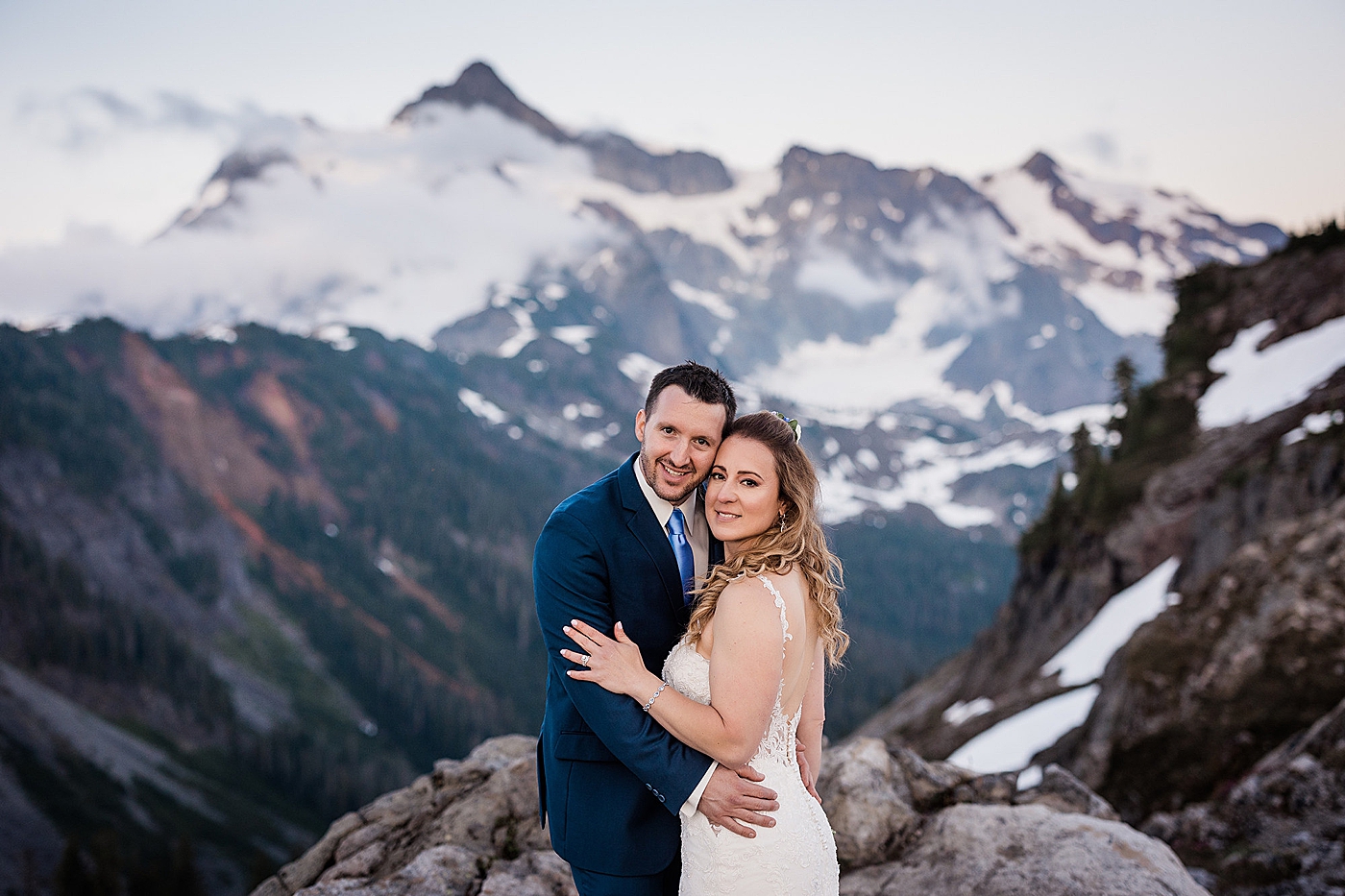 Couples portraits with stunning mountain views behind them. Photo by Megan Montalvo Photography.