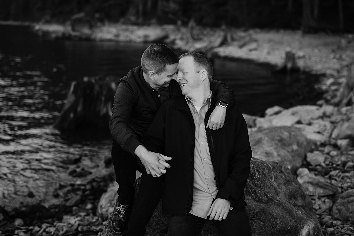 Black and white portrait of couple embracing during engagement session. Photo by Megan Montalvo Photography.