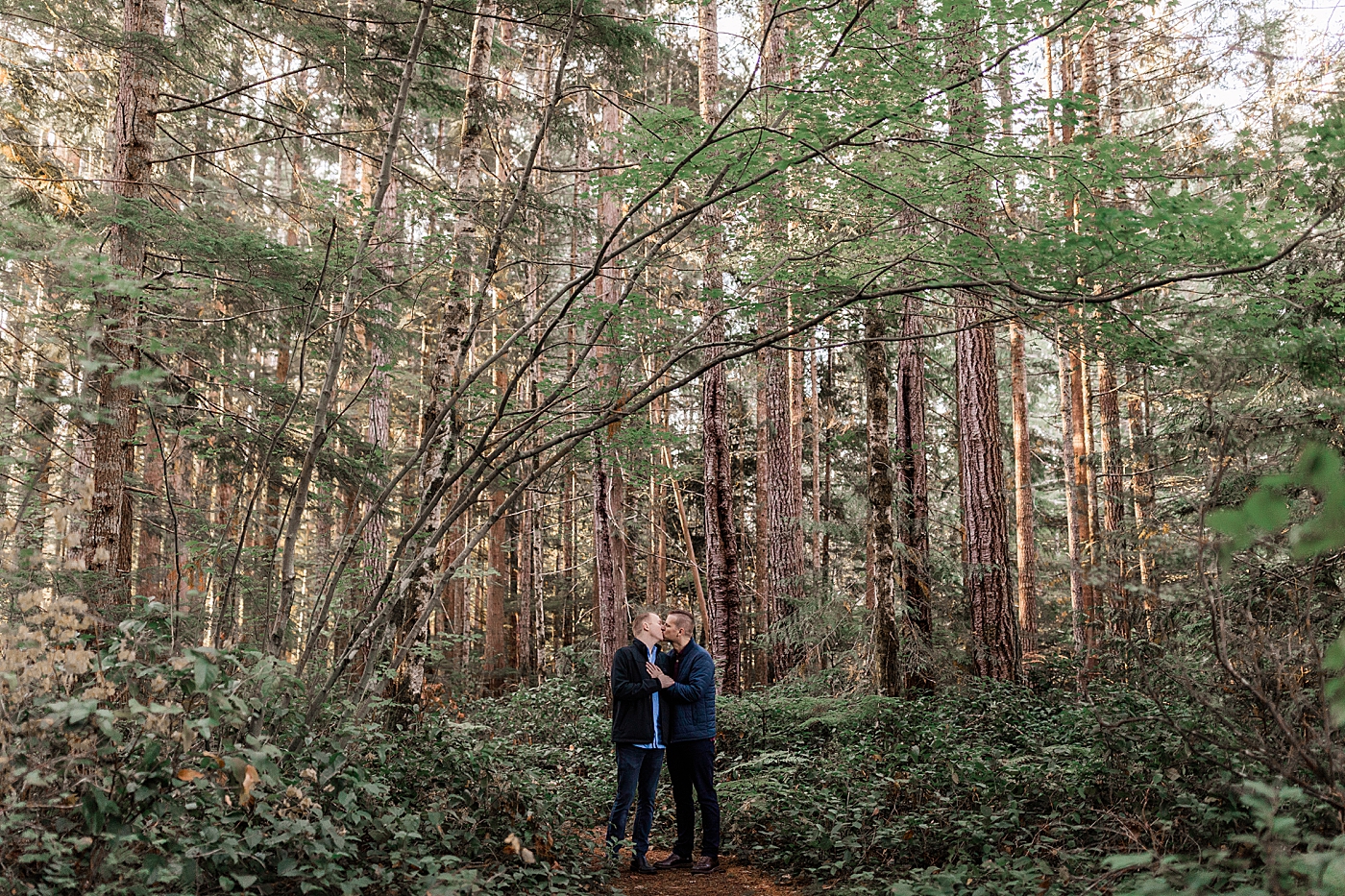 Couple kissing in the middle of the Olympic National Park. Photo by Megan Montalvo Photography.