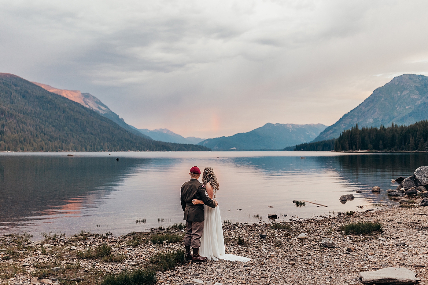 Couple looking out over Lake Wenatchee at sunrise. Photo by Megan Montalvo Photography.