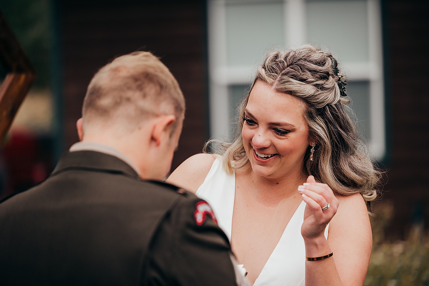 Bride laughing during vows. Photo by Megan Montalvo Photography.
