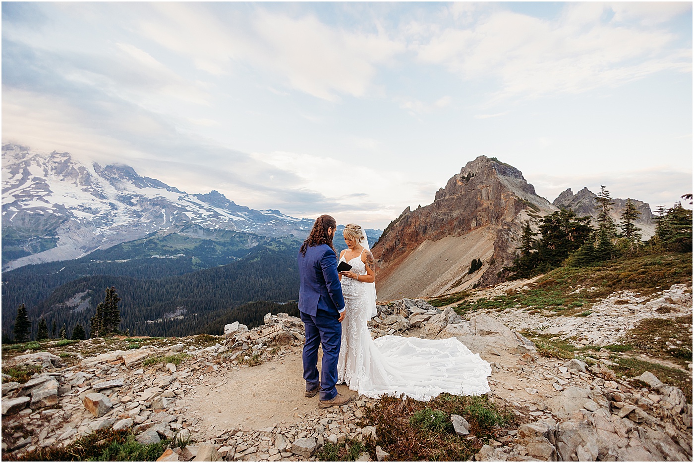 Couple exchanging vows during intimate elopement at Mount Rainier | Photo by Megan Montalvo Photography