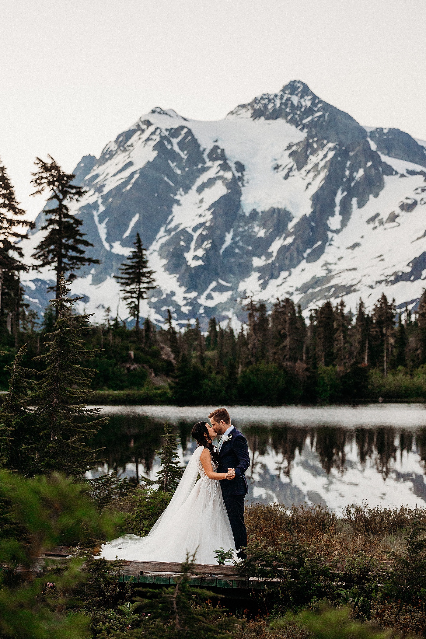 Couple kissing in front of Picture Lake | Megan Montalvo Photography