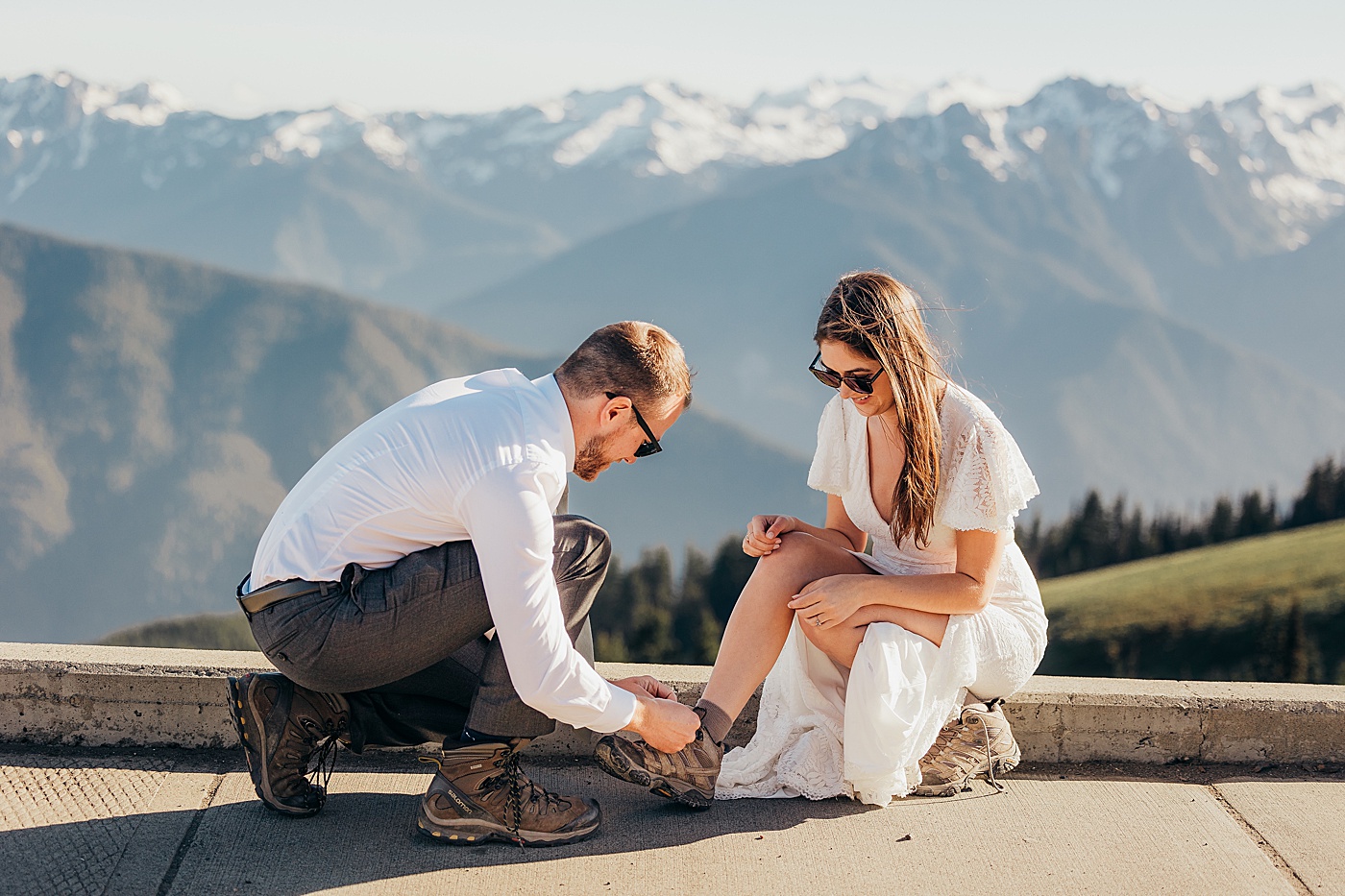 Groom helping bride with hiking shoes | Megan Montalvo Photography