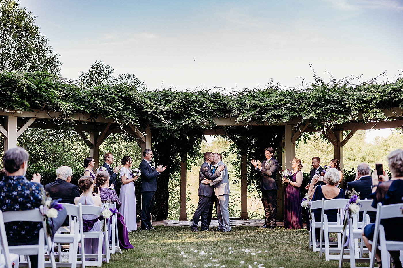 First kiss between the grooms at same-sex wedding at Sanders Estate in Washington state | Megan Montalvo Photography