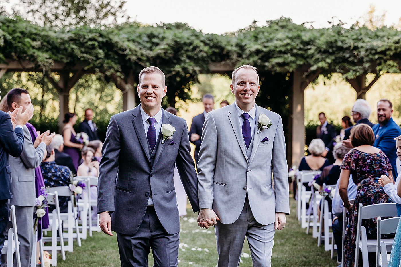 Newlyweds walking down the aisle after getting married at Sanders Estate | Megan Montalvo Photography