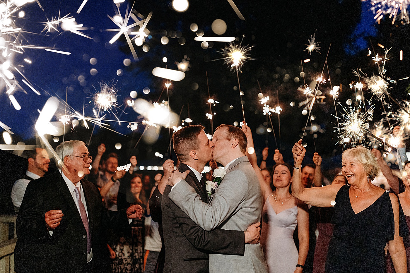 Grooms kissing during sparkler exit at Sanders Estate | Megan Montalvo Photography