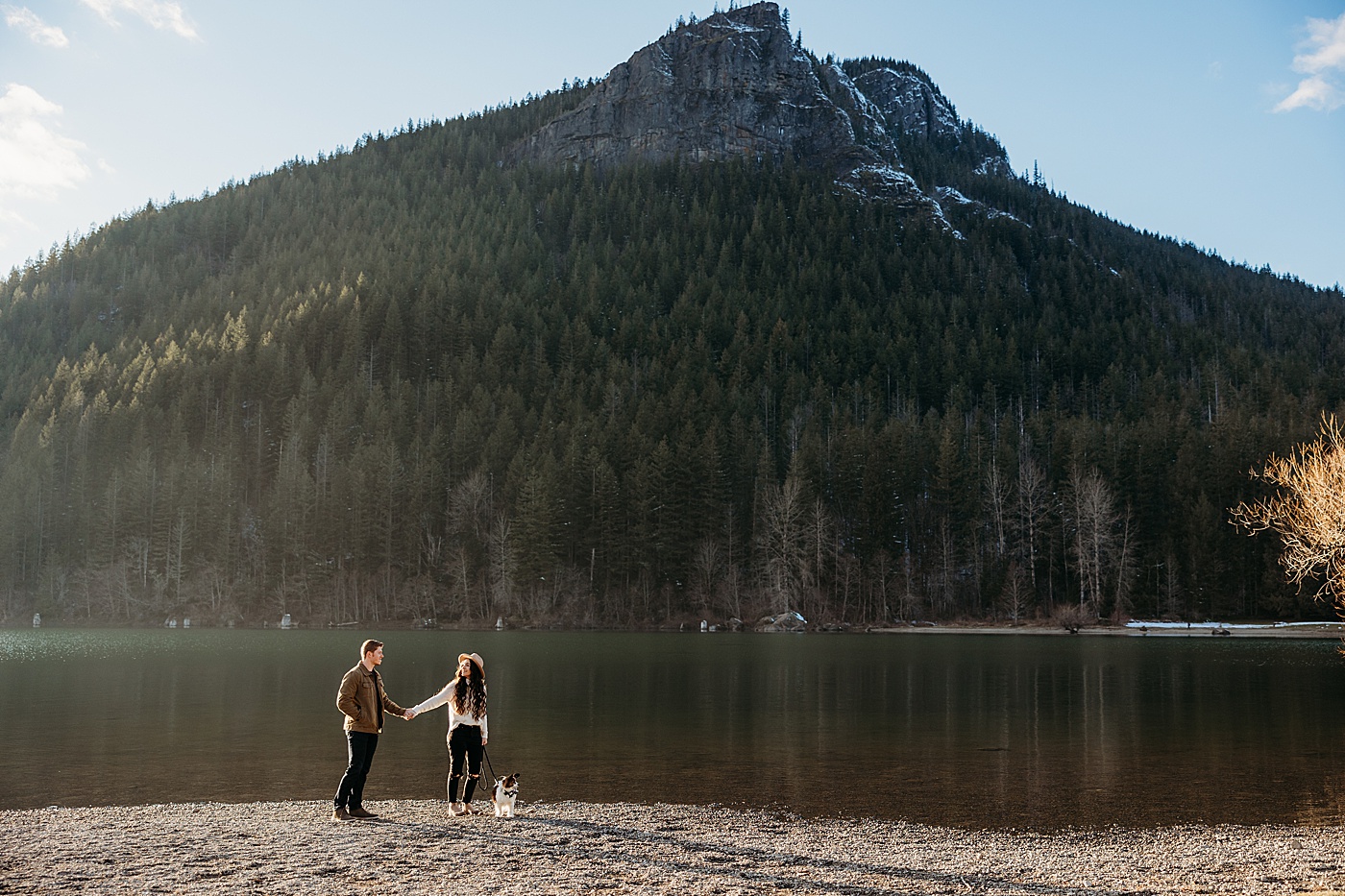 Couple walking along the water with dog at winter engagement session at Rattlesnake Lake | Megan Montalvo Photography