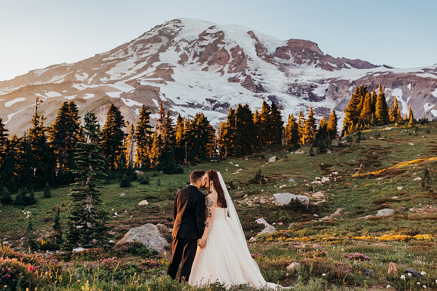 Newlyweds kissing after elopement on the Skyline Trail at Mount Rainier | Photo by Megan Montalvo Photography